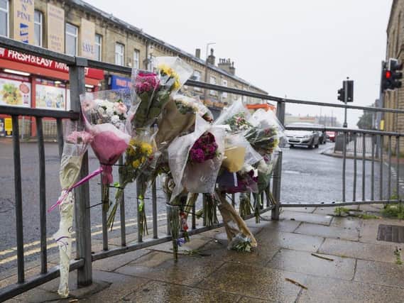 Flowers have been left at the scene in Queen's Road