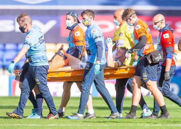 Leeds's Harry Newman is stretchered off after a leg injury against Hull KR last year. Picture: Allan McKenzie/SWpix.com