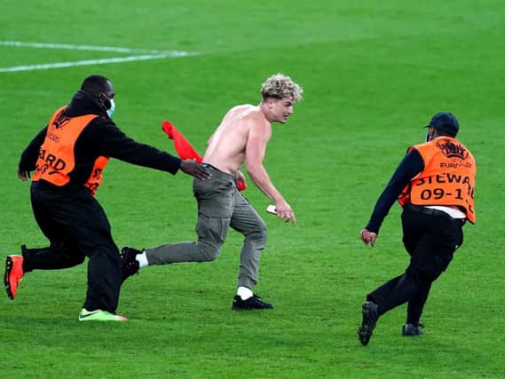 Stewards tackle a pitch invader during the UEFA Euro 2020 Final at Wembley Stadium, London. Picture: Mike Egerton/PA Wire