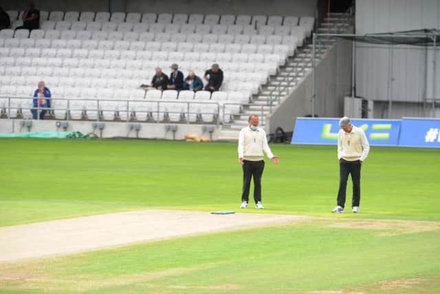 Umpires inspect the Headingley wicket, but the Roses match was abandoned as a draw.