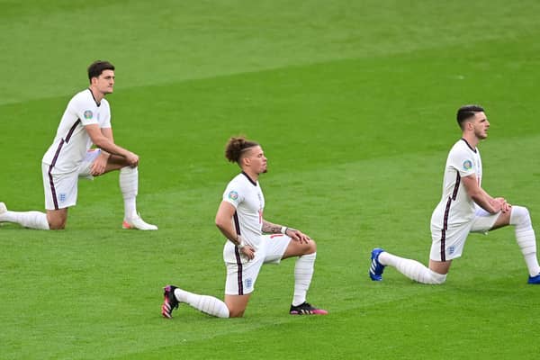 England's defender Harry Maguire, England's midfielder Kalvin Phillips and England's midfielder Declan Rice take the knee prior to the UEFA EURO 2020 Group D football match between Czech Republic and England at Wembley Stadium in London on June 22, 2021. (Photo by NEIL HALL / POOL / AFP).
