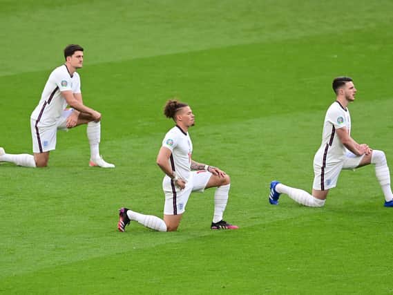 England's defender Harry Maguire, England's midfielder Kalvin Phillips and England's midfielder Declan Rice take the knee prior to the UEFA EURO 2020 Group D football match between Czech Republic and England at Wembley Stadium in London on June 22, 2021. (Photo by NEIL HALL / POOL / AFP).