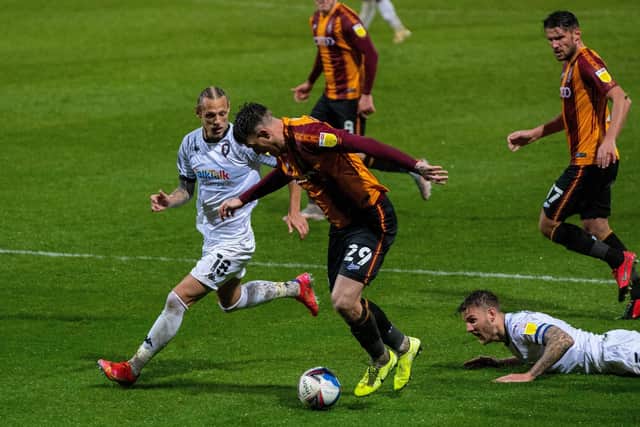 FAMILIAR FACE: Oscar Threlkeld closes in on Bradford City's Andy Cook during Salford's visit to Valley Parade last season.  Picture: Bruce Rollinson