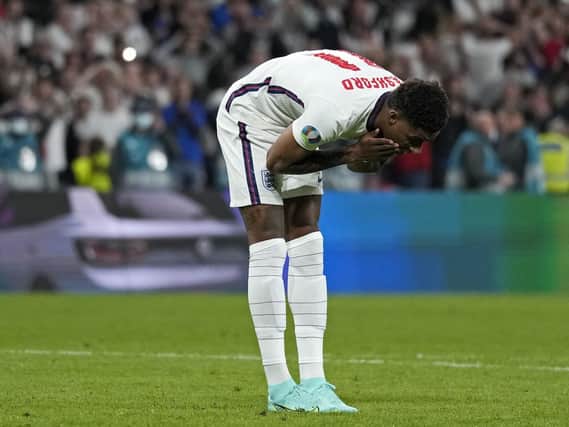 England's Marcus Rashford reacts after he missed during the penalty shootout of the Euro 2020 soccer championship final between England and Italy at Wembley stadium in London, Sunday, July 11, 2021. (AP Photo/Frank Augstein, Pool).