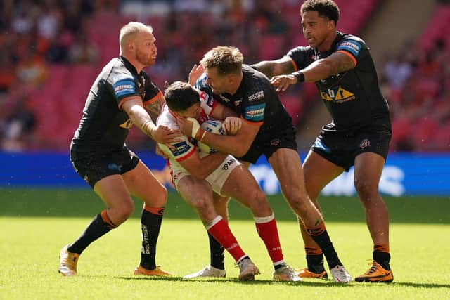 Held: St Helens' Lachlan Coote is tackled by Castleford Tigers' Michael Shenton. Picture: PA
