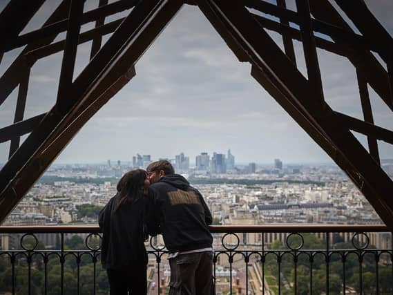A couple share a kiss at the top of the Eiffel Tower. PIC: Getty