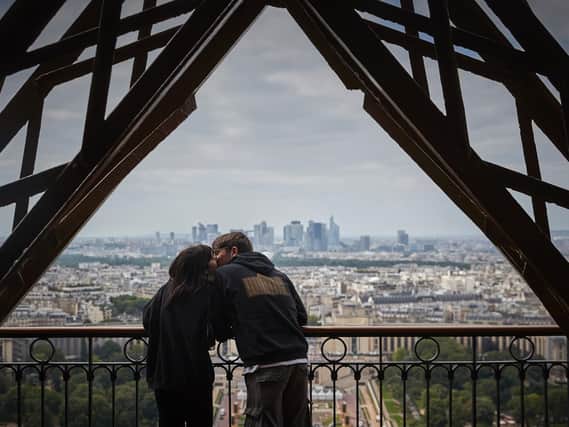 A couple share a kiss at the top of the Eiffel Tower. PIC: Getty