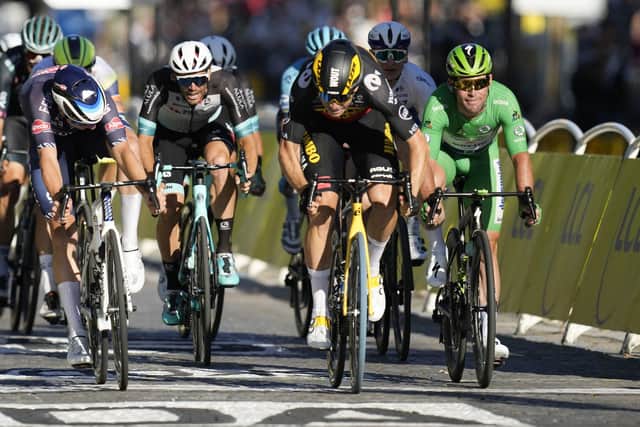 Britain's Mark Cavendish, wearing the best sprinter's green jersey, grimaces as Belgium's Wout Van Aert, center right, wins stage 21 on the Champs Elysees in Paris. Picture: AP/Christophe Ena