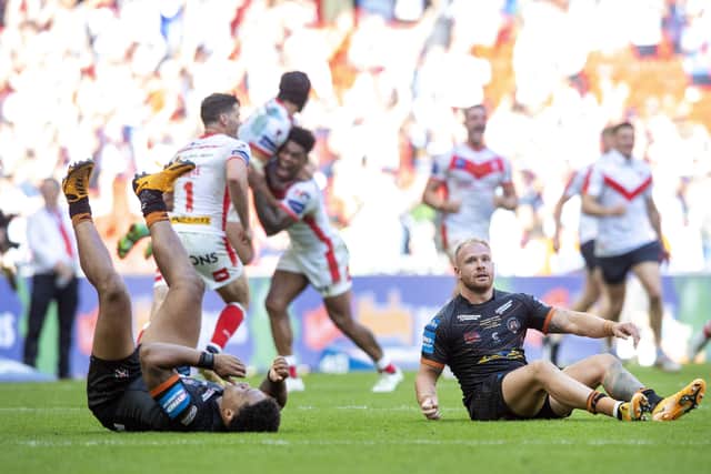 Despair: Jordan Turner and Oliver Holmes at full time as St Helens celebrate winning the Challenge Cup.
