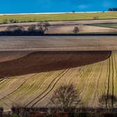 A farmer slowly ploughs a field during the early evening sun on the Wolds near Huggate, East Yorkshire. Picture: James Hardisty
