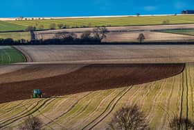 A farmer slowly ploughs a field during the early evening sun on the Wolds near Huggate, East Yorkshire. Picture: James Hardisty