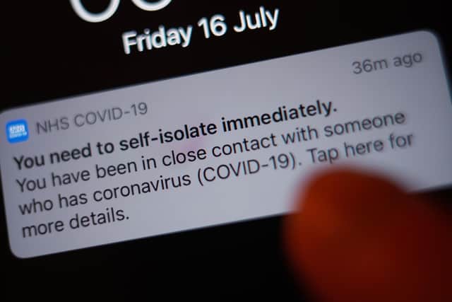 A notification issued by the NHS coronavirus contact tracing app - informing a person of the need to self-isolate immediately, due to having been in close contact with someone who has coronavirus - is displayed on a mobile phone  during the easing of lockdown restrictions in England.