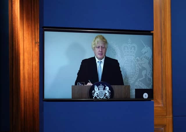 Prime Minister Boris Johnson appears on a screen from Chequers, the country house of the serving UK Prime Minister, where he is self-isolating, during a media briefing in Downing Street, London, on Covid-19.