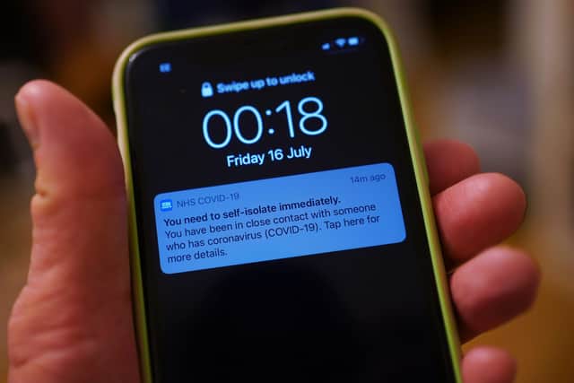 A notification issued by the NHS coronavirus contact tracing app - informing a person of the need to self-isolate immediately, due to having been in close contact with someone who has coronavirus - is displayed on a mobile phone.