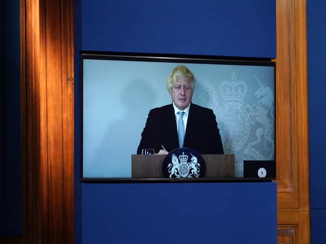Prime Minister Boris Johnson appears on a screen from Chequers, the country house of the serving UK Prime Minister, where he is self-isolating, during a media briefing in Downing Street, London  (PA/Alberto Pezzali)