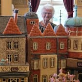 Margaret Seaman from Great Yarmouth, Norfolk, stands next to her creation 'Knitted Sandringham', on display in the Ballroom of Sandringham House