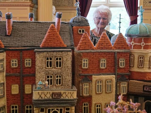 Margaret Seaman from Great Yarmouth, Norfolk, stands next to her creation 'Knitted Sandringham', on display in the Ballroom of Sandringham House