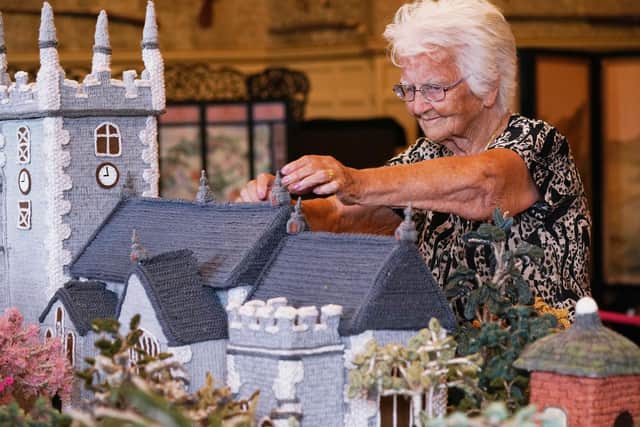 Ninety-two-year-old Margaret Seaman from Great Yarmouth, Norfolk, makes adjustments to her creation 'Knitted Sandringham'