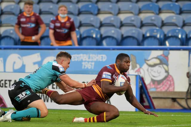 Huddersfield Giants' Jermaine McGillvary slides in for one of his four tries. (JONATHAN GAWTHORPE)
