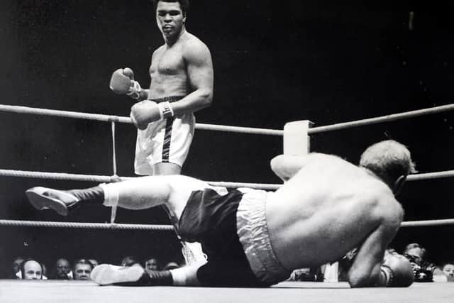 Ali knocks down Richard Dunn in their 1976 fight. (John Varley).