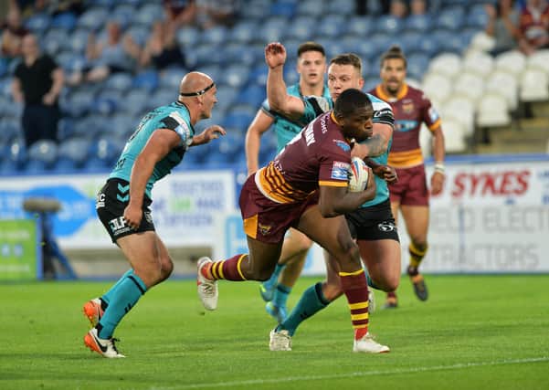 Star: Huddersfield's Jermaine McGillvary powers through to score his fourth try.
 
Picture : Jonathan Gawthorpe