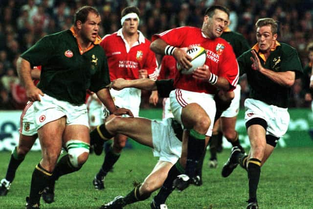 British Lions wing John Bentley attempts to break through the tackles of South Africa's Os du Randt (L) Pieter Rossouw (C) and Percival Montegomery. Picture: Mike Hutchings