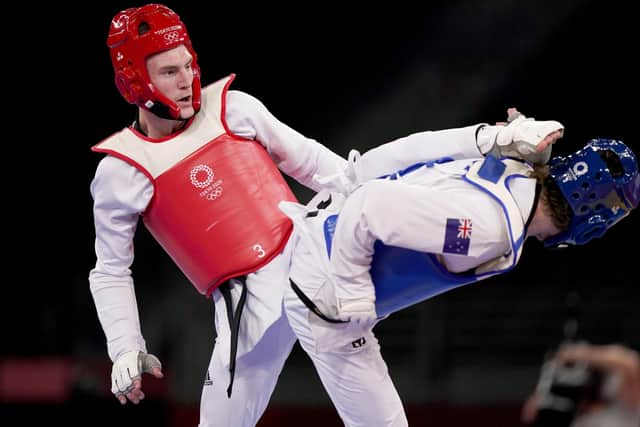 ON A ROLL: Bradly Sinden (left) lands a blow against New Zealand's Tom Burns in the Men's -68KG Round of 16 at Makuhari Messe Hall A. Picture: Mike Egerton/PA