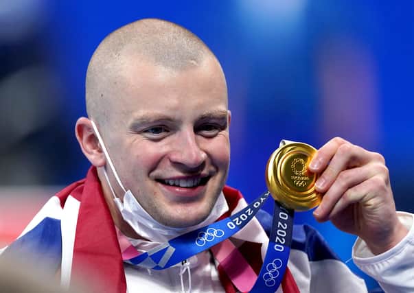 Gold: Great Britain's Adam Peaty poses with his gold medal on the podium after winning the Men's 100m Breaststroke final at the Tokyo Aquatics Centre.