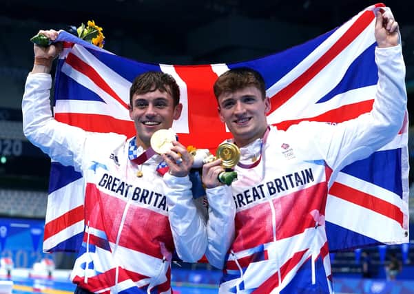 Stars: Great Britain's Tom Daley, left, and Matty Lee celebrate winning gold.