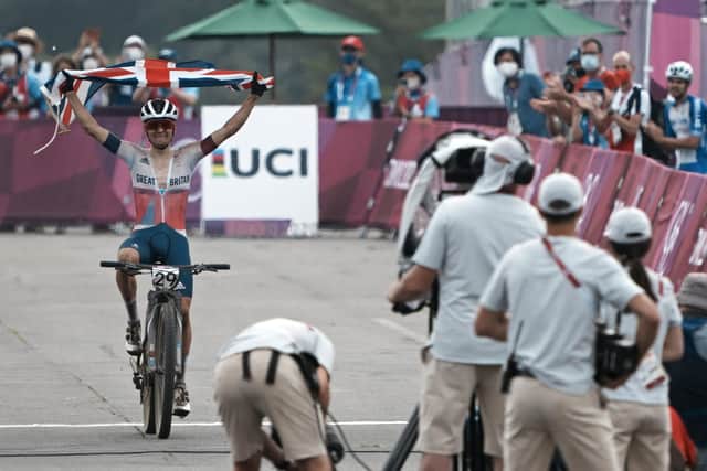 Victory: Tom Pidcock celebrates as he crosses the finish line to win the gold medal during the men's cross-country mountain bike competition.