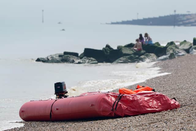 A boat thought to be used in a migrant crossing is left on the beach in Walmer, Kent, following a number of small boat incidents in the Channel.