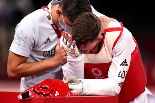 Great Britain's Bradly Sinden (right) appears dejected after getting silver in the Men's 68kg Gold Medal Contest against Uzbekistan's Ulugbek Rashitov at Makuhari Messe Hall A on the second day of the Tokyo 2020 Olympic Games in Japan.