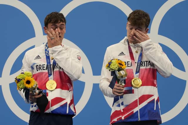 Thomas Daley and Matty Lee of Britain react after winning gold at the 2020 Summer Olympics, Monday, July 26, 2021, in Tokyo, Japan. (AP Photo/Dmitri Lovetsky)