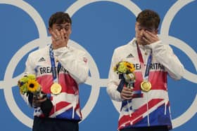 Tears of joy: Tom Daley and Matty Lee react after winning gold medals.