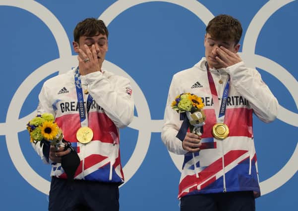 Tears of joy: Tom Daley and Matty Lee react after winning gold medals.