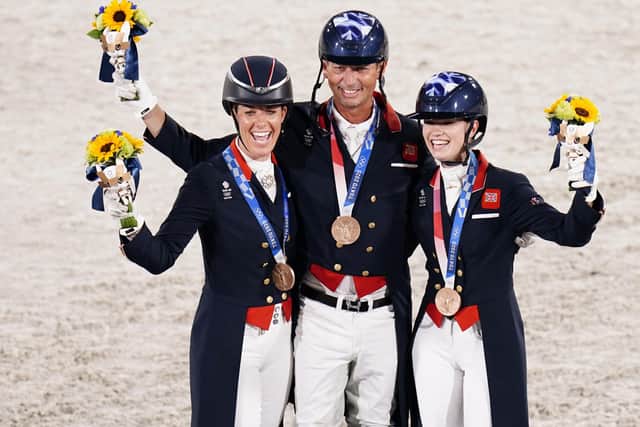Podium: Great Britain's Carl Hester (centre), Charlotte Fry (right) and Charlotte Dujardin (left) celebrate with their Bronze Medals during the Dressage Team Grand Prix Special. Picture: Danny Lawson/PA Wire.
