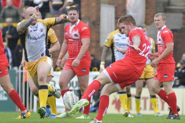Marc Sneyd gets a kick away for Salford against Castleford Tigers for Salford.