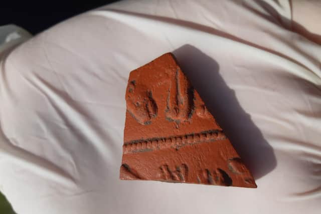 A Samian Ware fragment of pottery with a leopard, found in one of the ditches near the entrance to the playing field