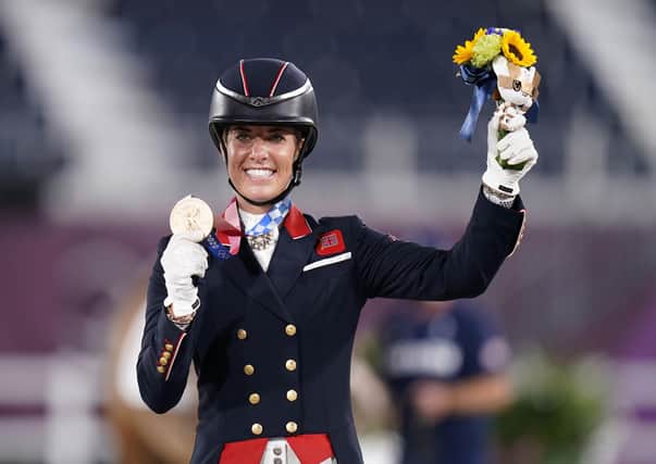 Great Britain's Charlotte Dujardin celebrates winning bronze in the Grand Prix Freestyle - Individual Final, on Gio, to become Great Britain's most decorated female Olympian with six medals, on the fifth day of the Tokyo 2020 Olympic Games in Japan.