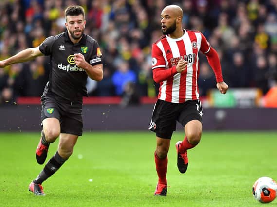 FRIENDLY: Norwich City's Grant Hanley challenges David McGoldrick for the ball the last time the sides met, at Bramall Lane in the last match before the first Covid-19 lockdown