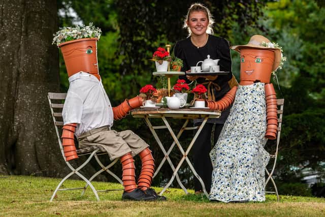 Pictured Isabella Munch, 21, the duty manager of the Falcon Manor, serving at the Botanical Afternoon Tea Party. The wacky creation is part of the 8th Settle Flowerpot Festival on display until early September. Photo credit: James Hardisty/JPIMedia