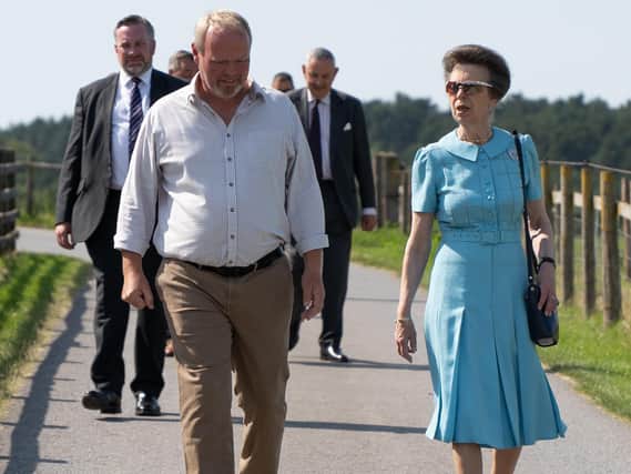 Princess Anne and her security detail with farmer Robert Nicholson