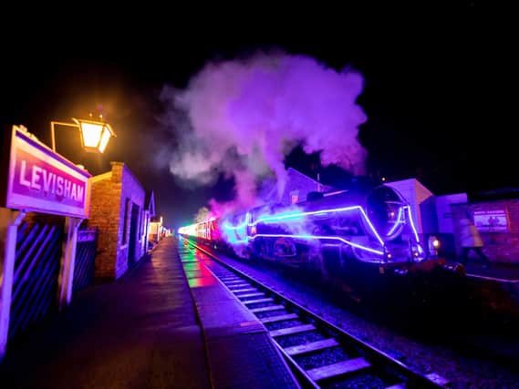 A lit up train at Levisham station on the North Yorkshire Moors Railway.