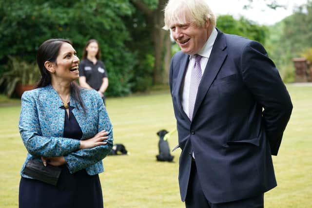 Prime Minister Boris Johnson and Home Secretary Priti Patel during a visit to Surrey Police headquarters in Guildford, Surrey, to coincide with the publication of the Government's Beating Crime Plan.