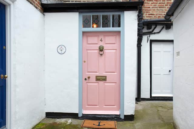 The door of Seapink cottage is painted in an appropriate colour