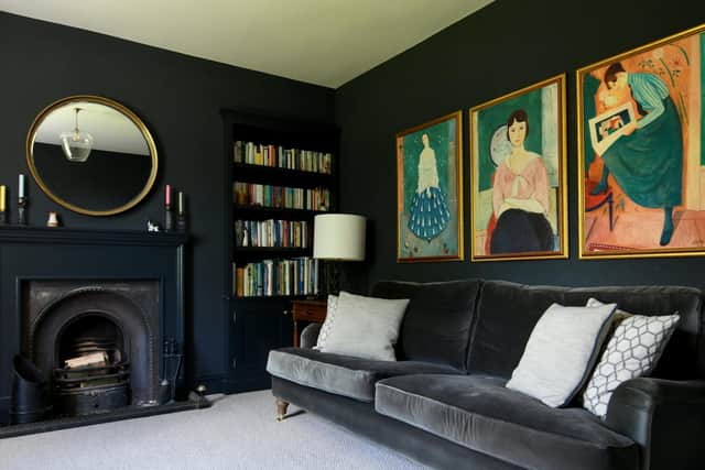 The sitting room painted in Farrow and Ball's Railings and with prints by  Swedish painter Einar Jolin.