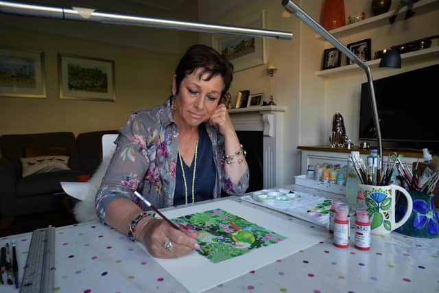 Linda's sons now help her publish and sell her paintings