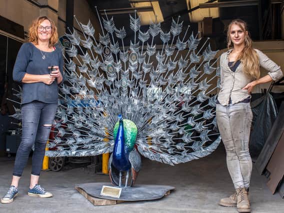 Janet Fraser and Katie Ventress with the peacock. Picture: Ernesto Rogata