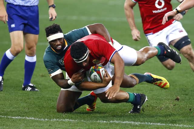 GOING NOWHERE: British & Irish Lions' Mako Vunipola is tackled by South Africa's Siya Kolisi in Cape Town. Picture: Steve Haag/PA
