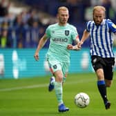 Sheffield Wednesday's Barry Bannan and Huddersfield Town's Lewis O'Brien battle for the ball. Picture: PA